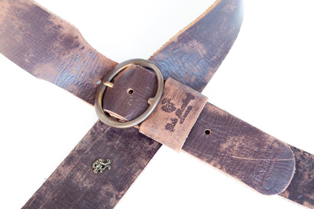 Relic guitar strap featuring distressed vintage leather and round buckle
