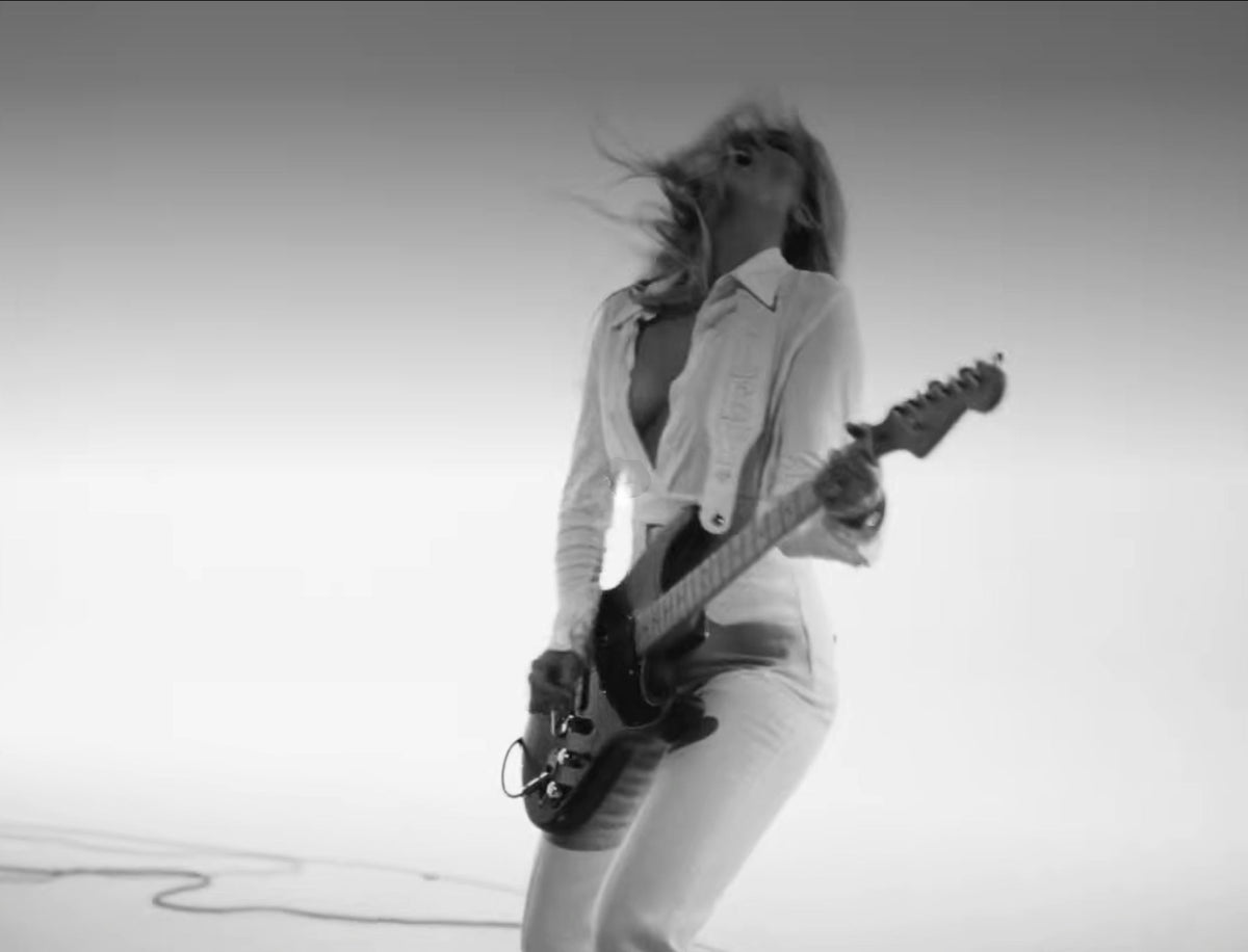 Custom white Red Monkey guitar strap created for Miley with tonal MILEY leather lettering