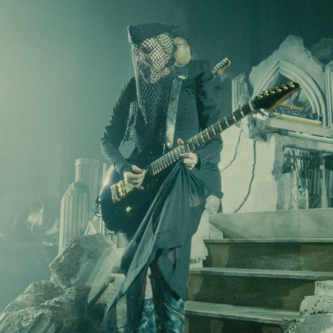 Lady Gaga performing during the Mayhem Requiem concert film featuring custom Red Monkey guitar straps.