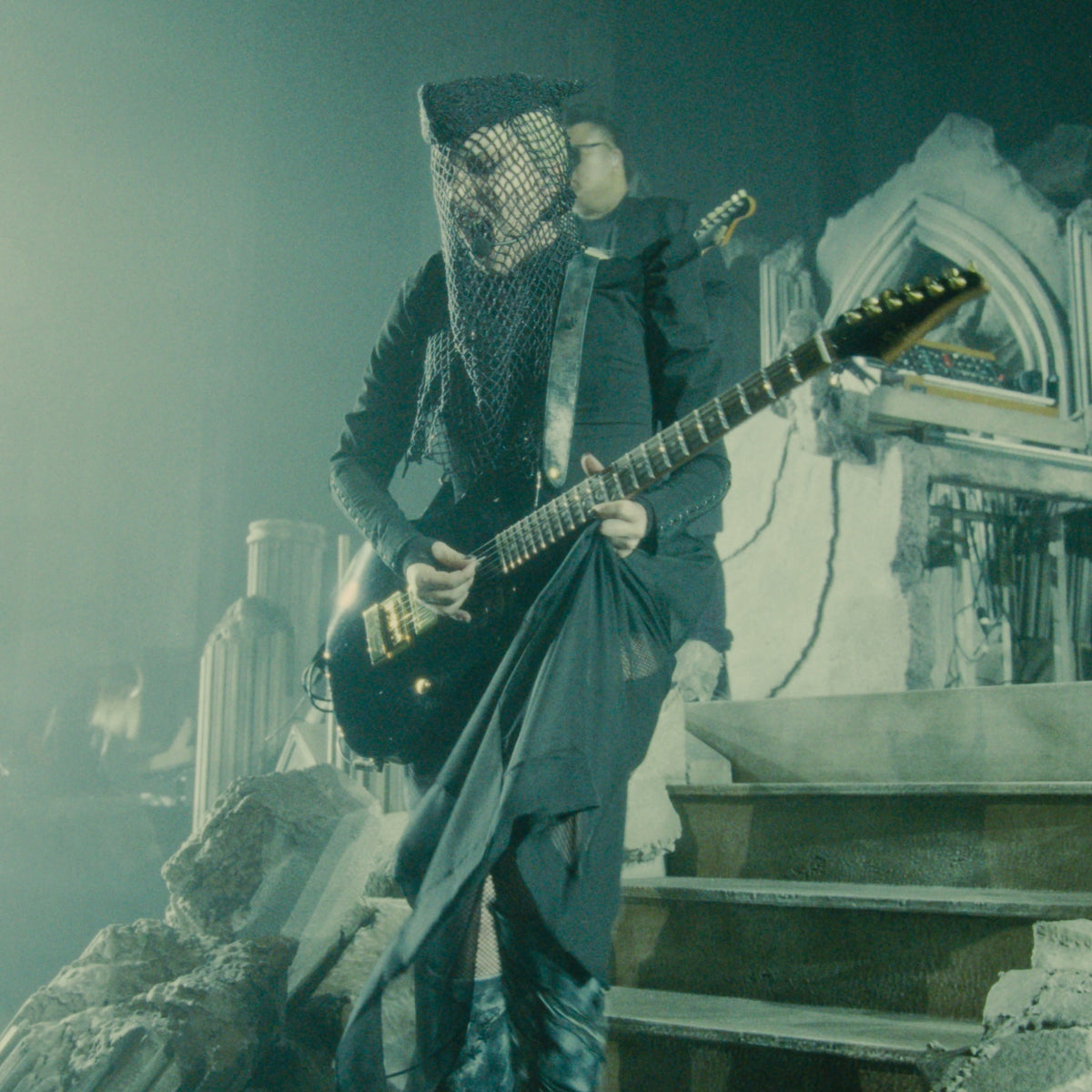 Lady Gaga performing during the Mayhem Requiem concert film featuring custom Red Monkey guitar straps.