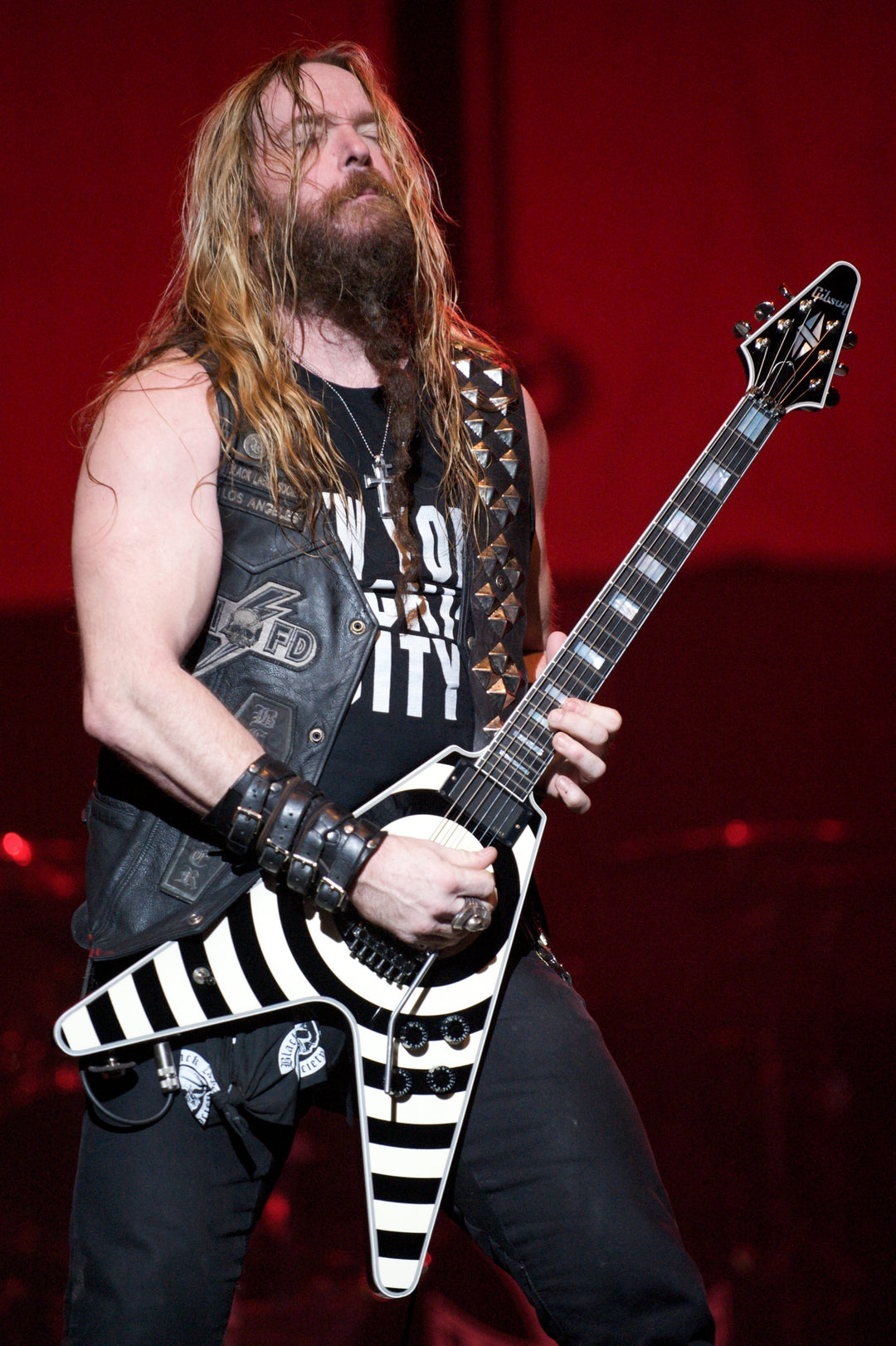 Zakk Wylde performing live with Black Label Society wearing a custom Red Monkey leather guitar strap