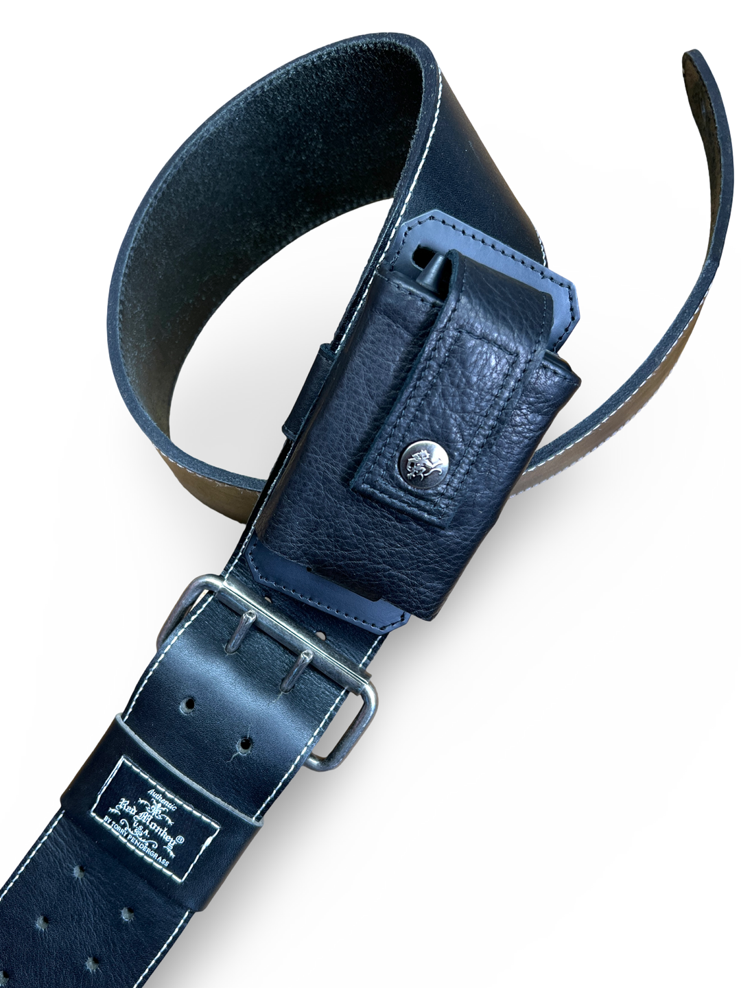 Close-up-Full guitar strap setup with black leather wireless pack transmitter holder