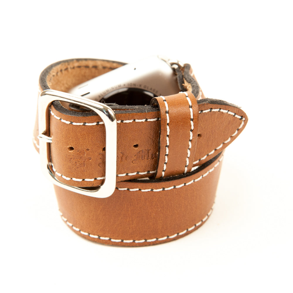 Hermes style Apple watch band that wraps twice around the wrist in brown leather with white stitch.