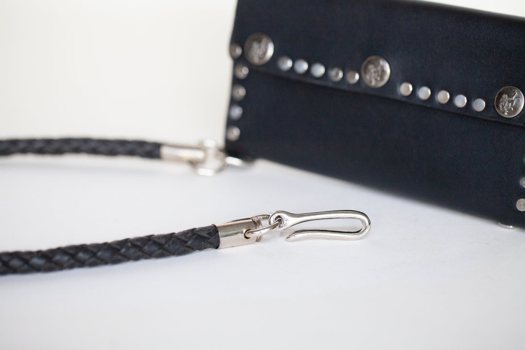Leather cord wallet chain with shell casings.