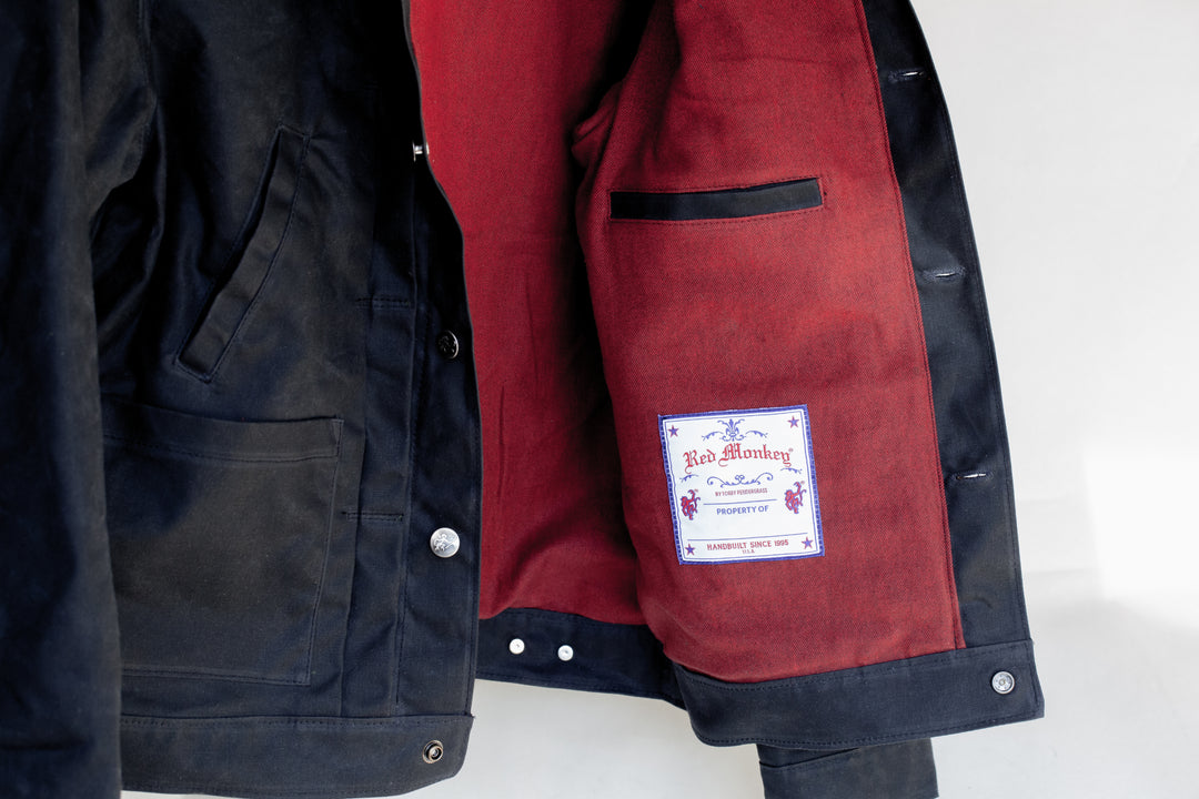 Red Monkey Property Of label on black waxed canvas jacket